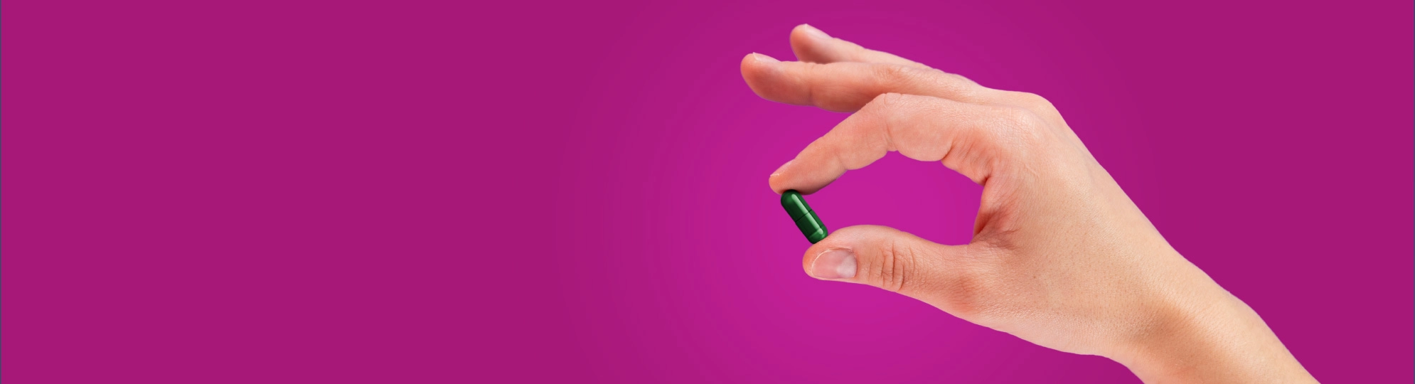Natural Pharmaceuticals Hepactum™ FORTE Egy kéz, amely egy kapszulát tart az ujjai között.